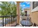 Relaxing balcony with wrought iron railings and cozy seating with lovely neighborhood views at 5464 Factors Walk Dr, Sanford, FL 32771