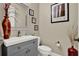 Elegant half bathroom featuring a modern vanity, mirror and tasteful decor at 5464 Factors Walk Dr, Sanford, FL 32771