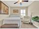 Comfortable bedroom with neutral tones, a bed, sitting chair, and plantation shutters for natural light at 5464 Factors Walk Dr, Sanford, FL 32771