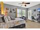 Bright bedroom features a comfortable bed, desk and chair, complemented by unique decorative accents at 5464 Factors Walk Dr, Sanford, FL 32771