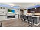 Modern kitchen featuring a fireplace, a wine fridge, and bar seating at 5464 Factors Walk Dr, Sanford, FL 32771