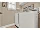 Bright laundry room featuring a modern washer and dryer and custom wall decor at 5464 Factors Walk Dr, Sanford, FL 32771