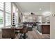Stylish open-concept dining and living area with wood floors and modern decor at 5464 Factors Walk Dr, Sanford, FL 32771