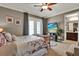 Spacious main bedroom with french doors, a cozy seating area, and serene ambiance at 5464 Factors Walk Dr, Sanford, FL 32771