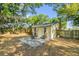 Backyard view featuring a home gym, a patio, and a quaint, yellow-painted house at 5750 Delta St, Orlando, FL 32807