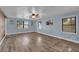 Light-filled bedroom with wood floors, blue walls, and multiple windows at 5750 Delta St, Orlando, FL 32807