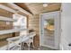 Cozy dining area with built-in seating, white chairs, and a view of the outdoors at 5750 Delta St, Orlando, FL 32807