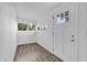 Bright foyer featuring wood-look floors, white walls, and natural light at 5750 Delta St, Orlando, FL 32807