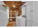 Functional laundry room with washer, dryer, shelving, and storage cabinets at 5750 Delta St, Orlando, FL 32807