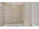 Bathroom showcasing the tiled shower and bath with neutral color scheme at 626 Green Rock Ct, Apopka, FL 32712