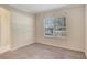 Empty bedroom features a window with blinds and neutral walls and carpeting at 626 Green Rock Ct, Apopka, FL 32712
