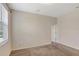 Spacious bedroom with carpet, neutral walls, and a door offering an inviting space at 626 Green Rock Ct, Apopka, FL 32712