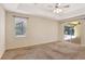 Bedroom with a ceiling fan, sliding doors to the patio, and a large window at 626 Green Rock Ct, Apopka, FL 32712