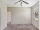 A charming bedroom featuring neutral walls, soft carpeting, and a modern ceiling fan at 626 Green Rock Ct, Apopka, FL 32712