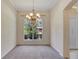 Bright dining room featuring a large window with detailed trim and a unique chandelier fixture at 626 Green Rock Ct, Apopka, FL 32712