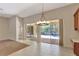 Dining area showcasing tile flooring, pendant lighting, and sliding glass doors to backyard pool at 626 Green Rock Ct, Apopka, FL 32712