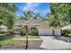 Charming home featuring a three-car garage, arched entryway and mature landscaping at 626 Green Rock Ct, Apopka, FL 32712