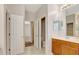 Hallway with view into bathroom with double door closet, and open door to toilet at 626 Green Rock Ct, Apopka, FL 32712