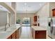 Open concept kitchen featuring stainless steel appliances and pool views at 626 Green Rock Ct, Apopka, FL 32712