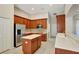 Modern kitchen with stainless appliances, white countertops, and wood cabinetry at 626 Green Rock Ct, Apopka, FL 32712