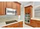 Well-equipped kitchen featuring stainless steel appliances and rich wood cabinetry at 626 Green Rock Ct, Apopka, FL 32712