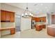 Bright kitchen with wood cabinetry, center island, and tiled floors at 626 Green Rock Ct, Apopka, FL 32712