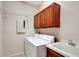 Functional laundry room including a washer, dryer, sink, and ample storage cabinets at 626 Green Rock Ct, Apopka, FL 32712