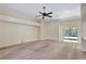 Spacious living room with neutral walls, carpet, and a sliding glass door at 626 Green Rock Ct, Apopka, FL 32712