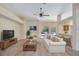 Bright living room with neutral tones, ceiling fan, and bar top at 626 Green Rock Ct, Apopka, FL 32712
