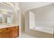 Bright bathroom featuring a soaking tub, separate shower, and vanity with cabinets at 626 Green Rock Ct, Apopka, FL 32712