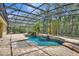 Beautiful screened pool featuring a rock waterfall, spa, and lush landscaping at 626 Green Rock Ct, Apopka, FL 32712
