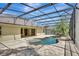 Screened-in lanai featuring a freeform pool with a waterfall feature at 626 Green Rock Ct, Apopka, FL 32712