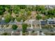 Overhead shot of the property and neighborhood showcasing the property's placement and tree coverage in a residential area at 6411 Merriewood Dr, Orlando, FL 32818