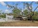 Expansive backyard featuring a two-car garage, upper deck and a covered patio under the deck perfect for outdoor entertaining at 6411 Merriewood Dr, Orlando, FL 32818