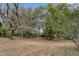 Expansive backyard with mature shade trees and playhouse at 6411 Merriewood Dr, Orlando, FL 32818