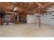 Large unfinished basement with concrete floor, painted walls and exposed beams at 6411 Merriewood Dr, Orlando, FL 32818
