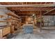 Unfinished basement featuring a workshop with shelving, utilities, and exposed wooden beams at 6411 Merriewood Dr, Orlando, FL 32818