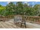 View of the home's wooden deck featuring a small table and two chairs, perfect for relaxing outdoors at 6411 Merriewood Dr, Orlando, FL 32818