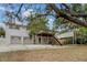 Rear exterior view with attached deck, two-car garage and covered carport at 6411 Merriewood Dr, Orlando, FL 32818