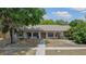 Charming single-story home featuring arched entryways and well-maintained front yard, creating a welcoming curb appeal at 6411 Merriewood Dr, Orlando, FL 32818