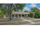 Charming single-story home featuring arched entryways and well-maintained front yard, creating a welcoming curb appeal at 6411 Merriewood Dr, Orlando, FL 32818