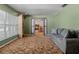 Comfortable living room with a large window and view into office area at 6411 Merriewood Dr, Orlando, FL 32818