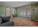 Cozy living room featuring a comfortable sofa, window, and built in shelving at 6411 Merriewood Dr, Orlando, FL 32818
