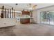 Open-concept living room with access to deck and view of kitchen with wood cabinets at 6411 Merriewood Dr, Orlando, FL 32818