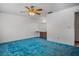 Spacious main bedroom featuring a vanity area and blue carpet flooring at 6411 Merriewood Dr, Orlando, FL 32818