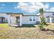 A view of the backyard showcasing a covered patio and landscaping in this lovely home at 667 Pennywort St, Lake Alfred, FL 33850