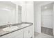 Bright bathroom featuring dual sinks with granite countertops and modern fixtures at 667 Pennywort St, Lake Alfred, FL 33850