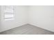 Bedroom features neutral carpet, a window with blinds, and fresh paint at 667 Pennywort St, Lake Alfred, FL 33850