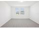 Airy bedroom with neutral carpet, white walls, and natural light from a pair of double windows at 667 Pennywort St, Lake Alfred, FL 33850