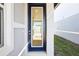 Stylish blue-framed glass front door offering a glimpse of the home's interior at 667 Pennywort St, Lake Alfred, FL 33850